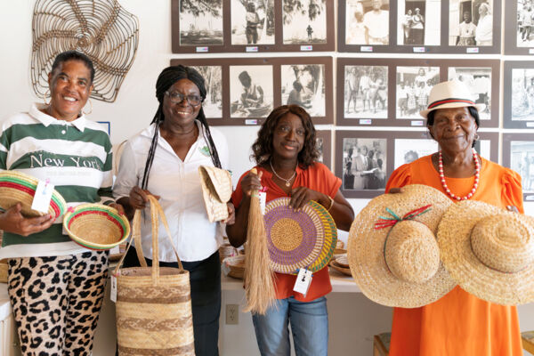 Artisans holding their straw work crafts at the Middle Caicos Co-op shop on North Caicos. 