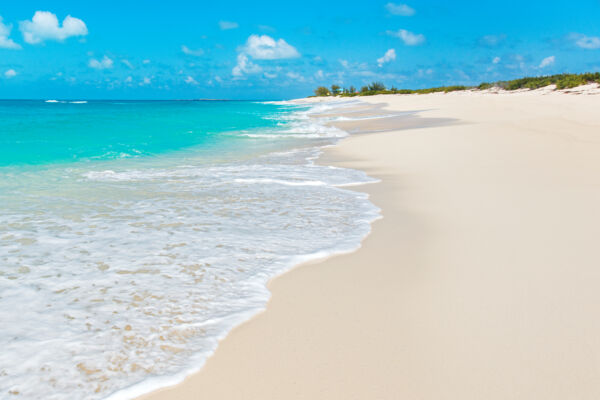 The turquoise Atlantic Ocean and white sand at North Bay Beach on Salt Cay