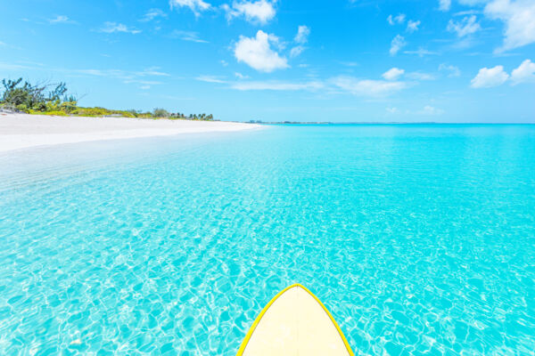 Paddleboard in clear turquoise water at Leeward Beach in the Turks and Caicos