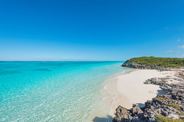 Clear ocean water and the small beach at Pumpkin Bluff on North Caicos