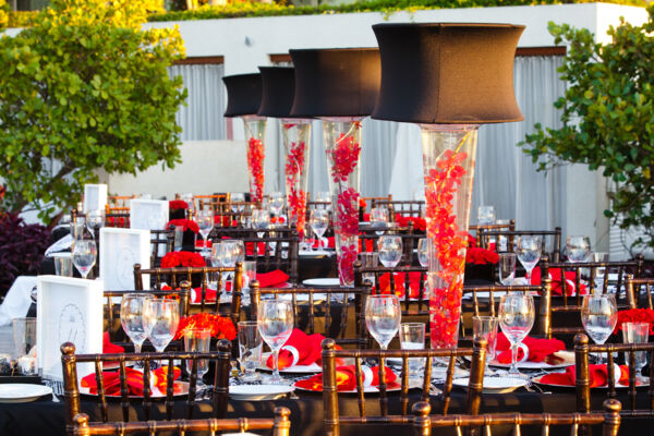 Red flower place settings and decorations at a corporate dinner event in the Turks and Caicos