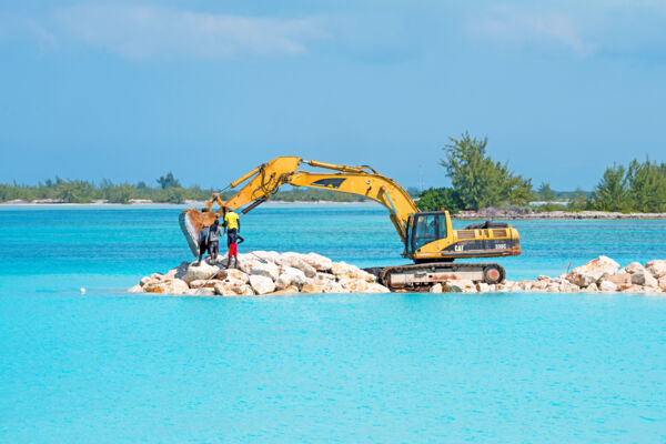 Excavator building a rock jetty at Leeward Beach on Providenciales 