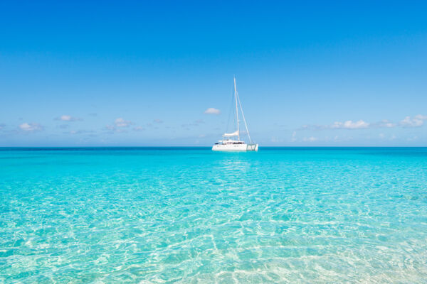 Catamaran sailing charter in the sparkling ocean water off of Water Cay