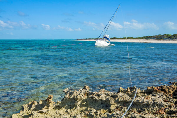 Small yacht sailboat grounded on a shoal at Northwest Point on Providenciales