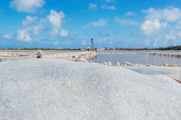 Pile of sea salt and a windmill pump at a salina on Grand Turk