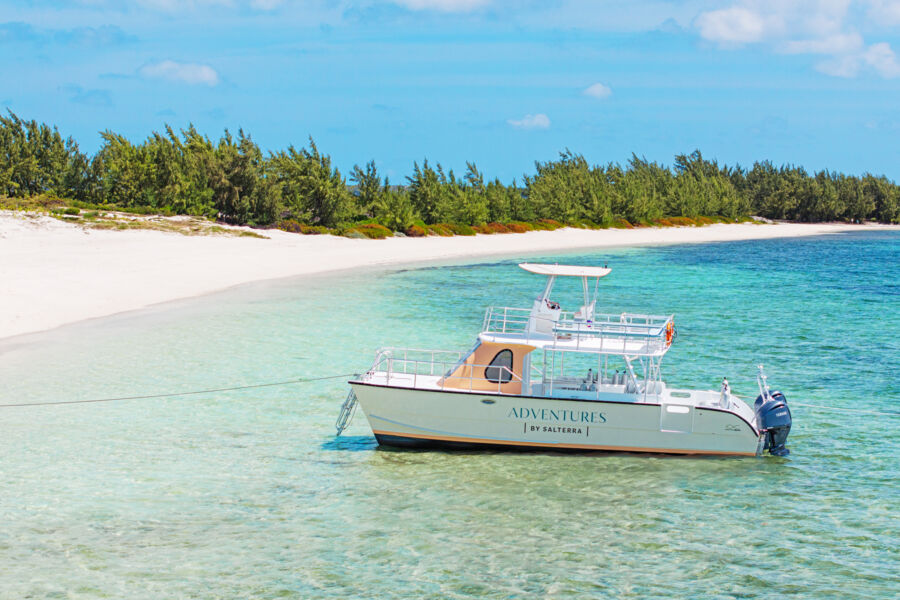 Scuba diving boat anchored off a beautiful beach.