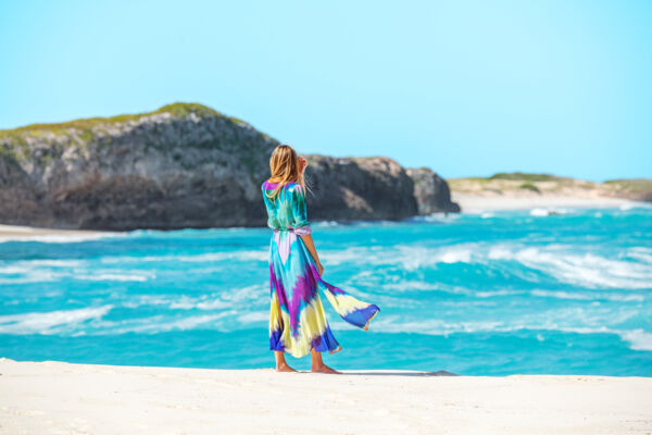 Woman on beach in front of Mudjin Harbour, Turks and Caicos.
