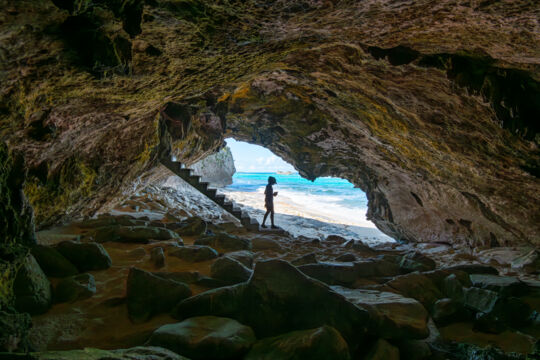 Person in the secret cave at Mudjin Harbour, Turks and Caicos. 
