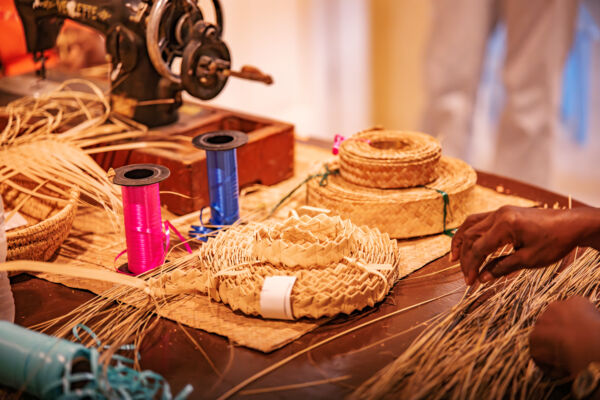 Straw work basket weaving station inside a shop.