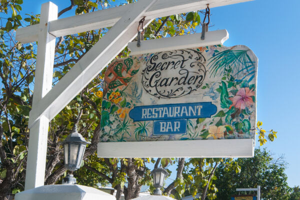 Colourful sign for the Secret Garden Restaurant at the Salt Raker Inn in the Turks and Caicos