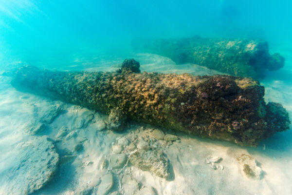British 1700s cannons underwater at the site of Fort Saint George in the Turks and Caicos