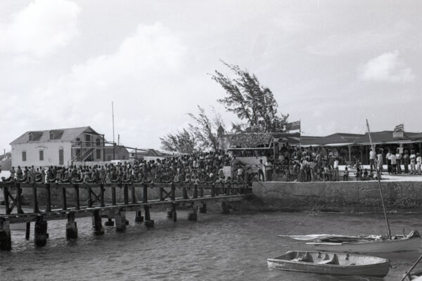 The pier and crowds at Conch Ground at South Caicos during the South Caicos Regatta in 1968