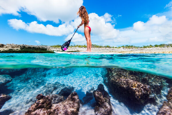 Stand up paddle boarder on the coast of the Northwest Point Marine National Park