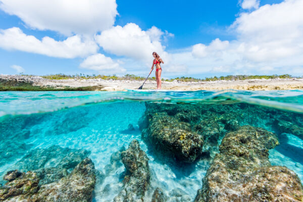 Amazing clear ocean water and paddle boarder in the Turks and Caicos