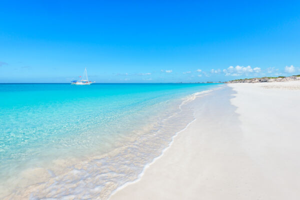 A charter excursion sailboat cruising off of the secluded Water Cay Beach