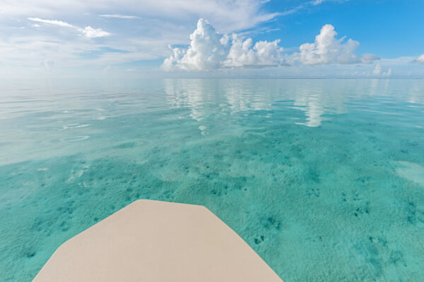 Boat on the shallow and clear water of the Caicos Banks