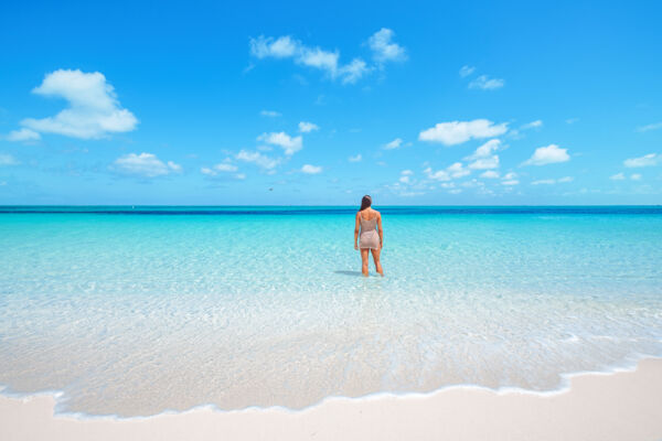 Woman standing in shallow water at The Bight Beach.
