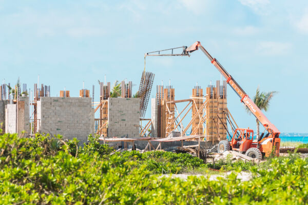 Telehandler placing steel rebar assembly at construction site in the Turks and Caicos