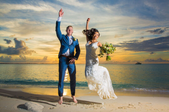 sunset with bride and groom on the beach