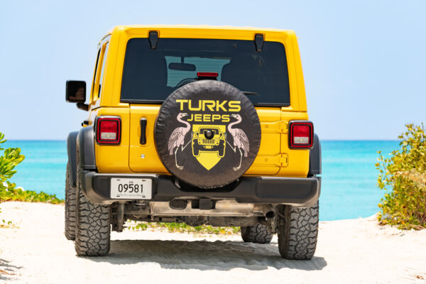 Yellow Jeep Wrangler by the ocean.