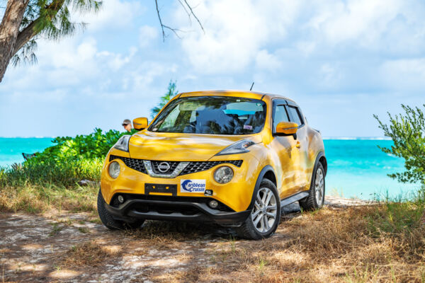 Yellow rental car parked at Hollywood Beach on North Caicos.