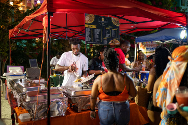 Vendor serving seafood at a fish fry. 