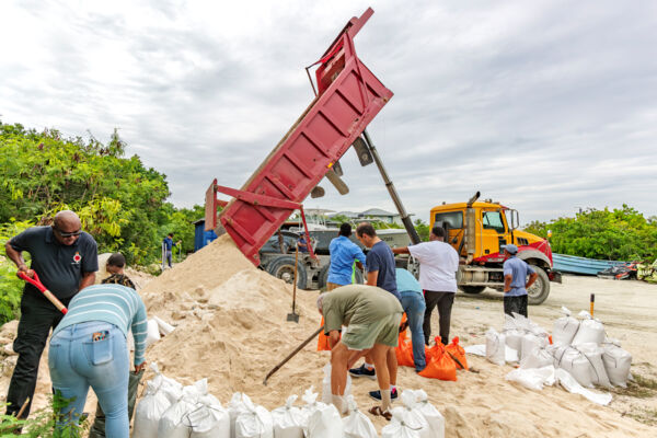 People filling up sand bags in Turks and Caicos to prepare for Hurricane Melissa. 