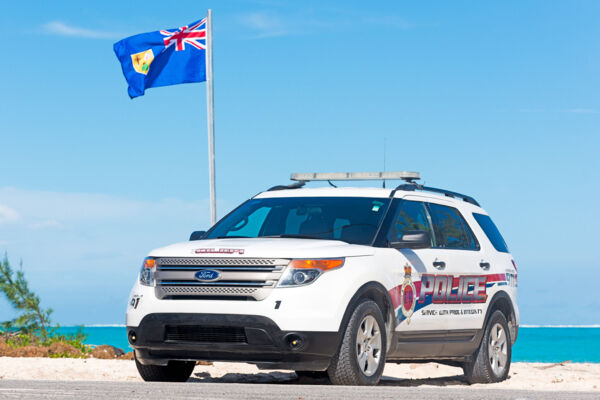 Police vehicle near the beach, Turks and Caicos Islands. 