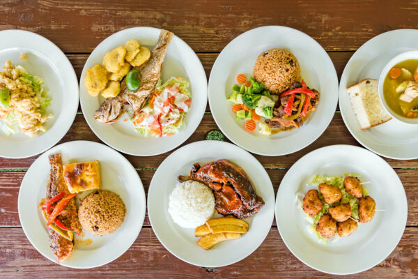 Plates of Caribbean food at a restaurant. 