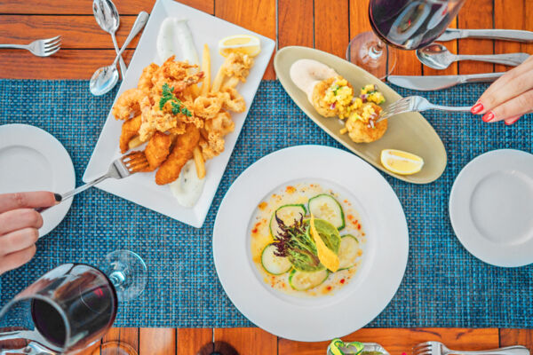 Overhead of several plates of seafood at a restaurant
