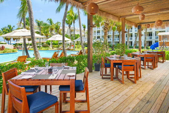 Dining tables overlooking a resort pool