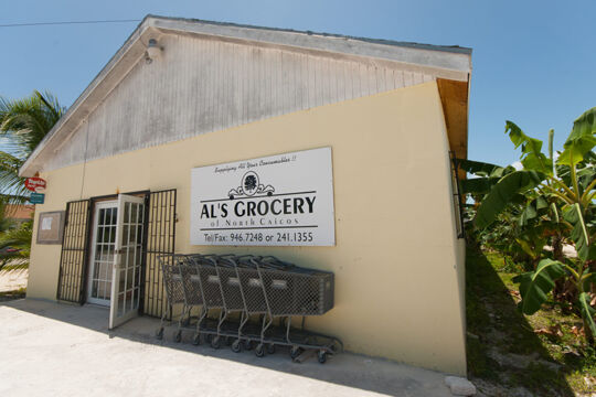 Exterior of a small grocery store and parked shopping carts