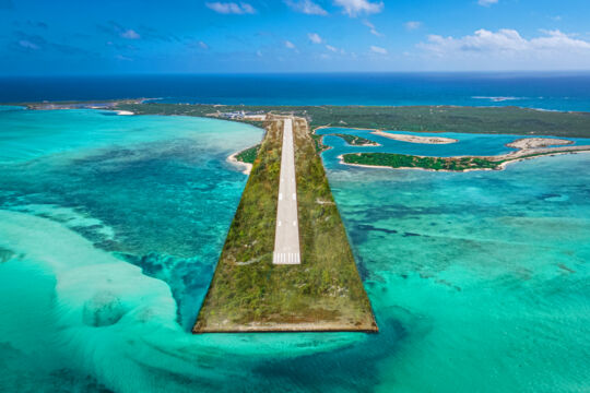 Private island runway surrounded by turquoise ocean