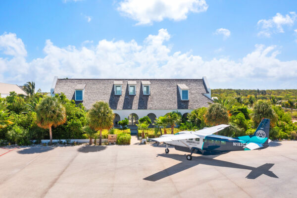 Private plane parked on apron at small Caribbean airport