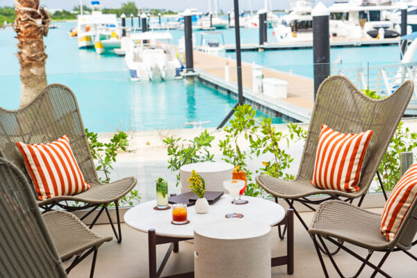 Cocktails on a table overlooking a marina with turquoise water