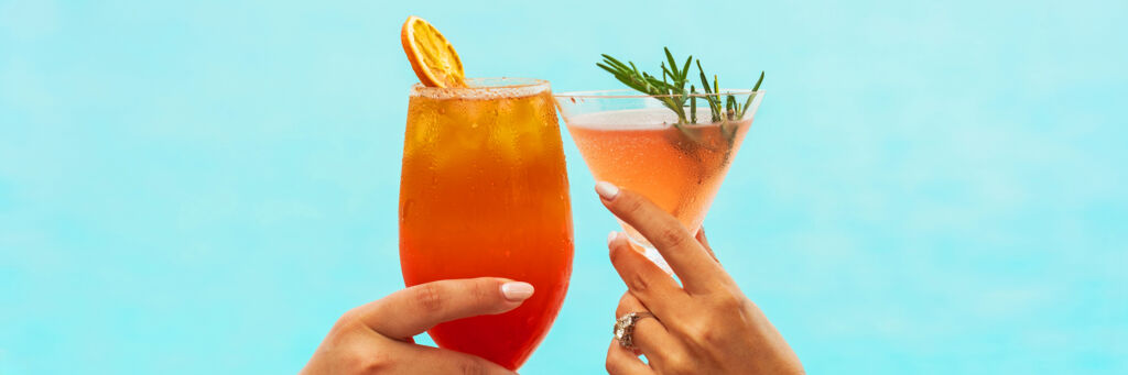 Cocktails clinking glasses