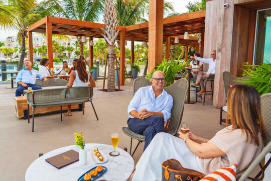 People enjoying cocktails and tapas at a restaurant terrace