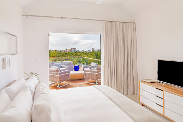 Bedroom with view of native forest and Grace Bay.