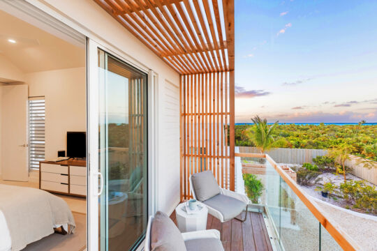 Private balcony at a villa with a view of the beach.