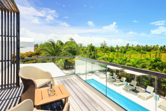Balcony overlooking a pool and tropical forest