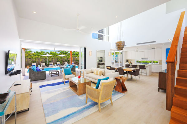An open-concept living and dining area in a modern villa in Turks and Caicos.