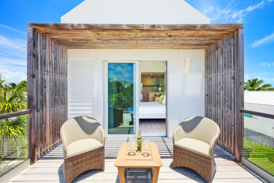 Villa balcony with lounge chairs off bedroom