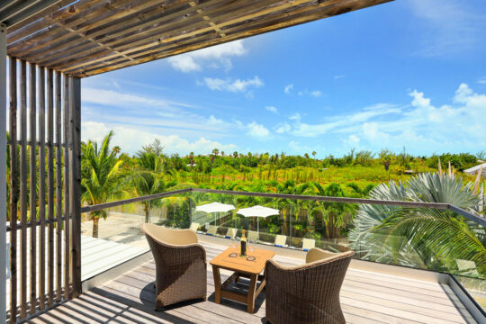 Villa patio overlooking tropical greenery.