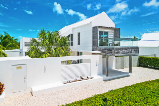 Exterior of a modern villa with a gravel driveway