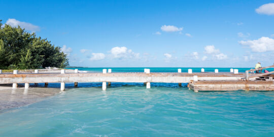 Small wood pier on the beach at Bambarra on Middle Caicos