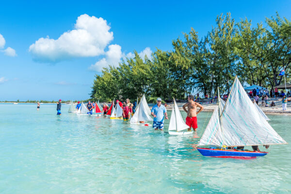 Dozens of model Caicos Sloop sailboats at Bambarra Beach during the Valentine's Day Cup