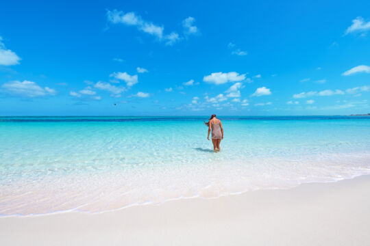 Bight beach and person
