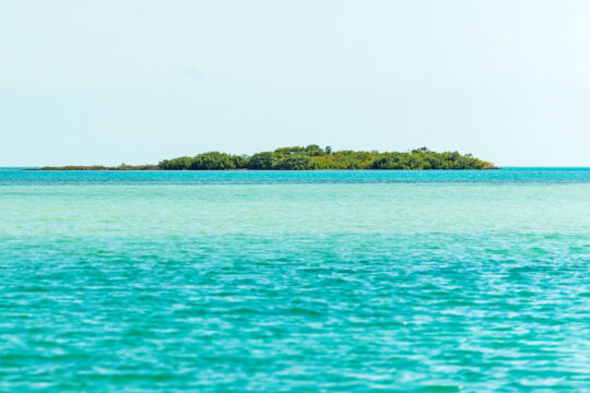 The lush island of Bird Cay surrounded by turquoise water