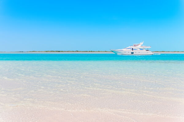 A luxury yacht in turquoise water in the Turks and Caicos