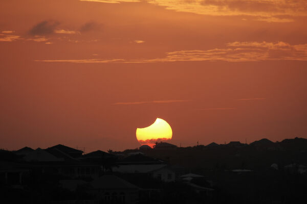 Solar eclipse over Blue Mountain, Turks and Caicos